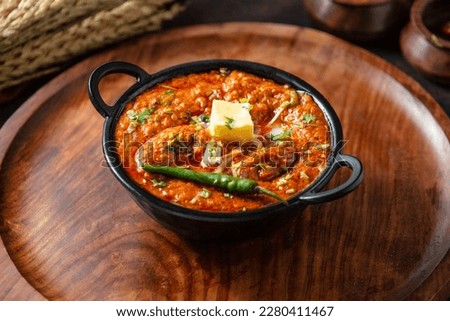 Butter chicken is a popular Indian dish that is made with boneless chicken that is marinated in yogurt and a blend of aromatic spices. Royalty-Free Stock Photo #2280411467
