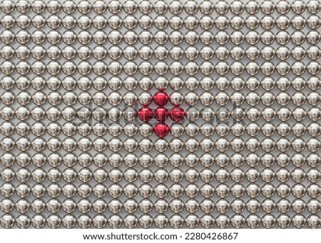 Silver magnetic balls with a red plus sign in the center. Target concept