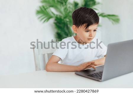 education online online games boy sits at the computer in the office