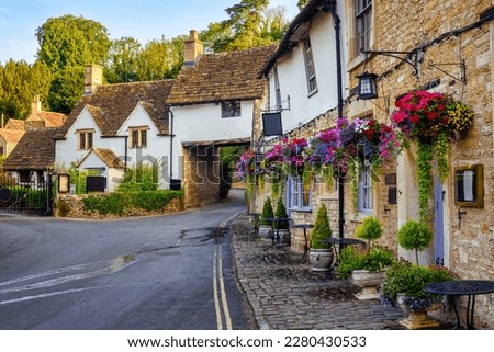 Traditional stone houses in Castle Combe village, one of the most visited picturesque villages in Cotswolds, England, United Kingdom Royalty-Free Stock Photo #2280430533