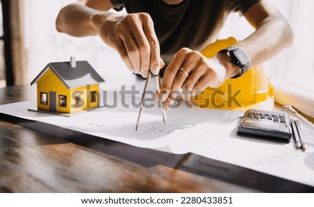 Construction and structure concept of Engineer or architect meeting for project working with partner and engineering tools on model building and blueprint in working site, contract for both companies. Royalty-Free Stock Photo #2280433851