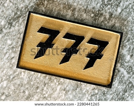 High angle view of golden house number plate on granite underground Royalty-Free Stock Photo #2280441265