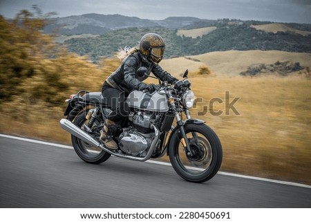 woman riding on classic motorcycle  Royalty-Free Stock Photo #2280450691