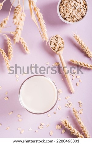 A glass of fresh oat milk and oatmeal. Vegan dairy-free organic drink. Top and vertical view Royalty-Free Stock Photo #2280463301