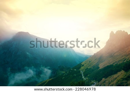 Fog in mountains. Fantasy and colorfull nature landscape. Nature conceptual image. Royalty-Free Stock Photo #228046978