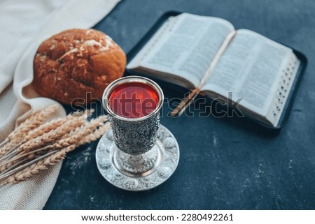 Wine, bread and open bible, communion concept.