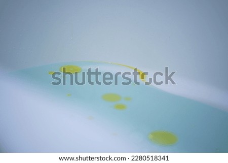 Oil art on light blue water
