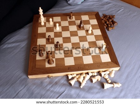 Chess Game ending: Checkmate chessboard Rook and King in battle on a bed with pawns, bishops, and other pieces already removed
