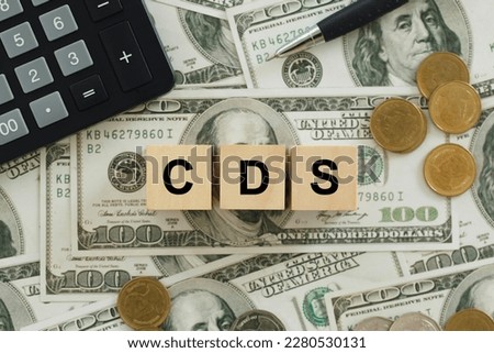 text CDS wrote on wooden cubes On top of the dollar bills. It is an abbreviation for credit default swap. a financial derivative that allows an investor to swap his credit risk.credit default swap Royalty-Free Stock Photo #2280530131