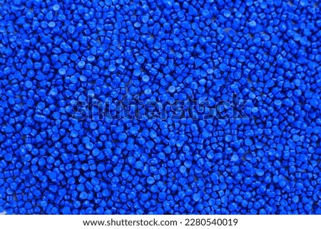 Close-up of blue plastic polymer granules. polymer plastic. compound polymer. PVC resin compounds. Tinted plastic granulate for injection moulding process. Royalty-Free Stock Photo #2280540019