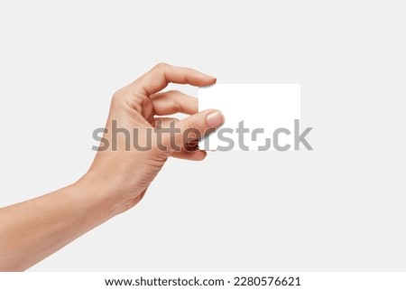 Woman's hand showing credit card, or card, or business card or voucher, isolated on white background, template, mock-up	
