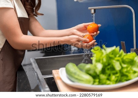 Asian woman making healthy food salad To take care health eat food that are beneficial to body Do it with cleanliness such as washing your hand before doing symptoms washing vegetables before eating