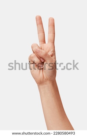 Woman hand showing Victory sign isolated, two fingers up Royalty-Free Stock Photo #2280580493