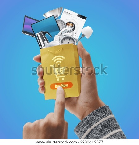 Customer ordering products online and holding a small shopping bag full of goods, online shopping concept Royalty-Free Stock Photo #2280615577