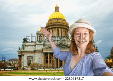 tourist taking selfie with landmarks, Russian journey, tourist international trip,tourism and travel, happy woman in hat is photographed with St. Isaac's Cathedral in st. petersburg in Russia