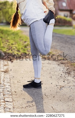 Young woman in sports clothes goes to run outdoor