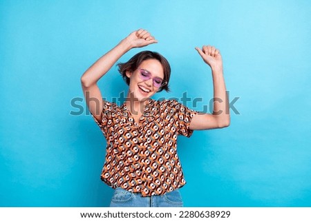 Photo of carefree positive girl enjoy dancing partying have good mood isolated on blue color background