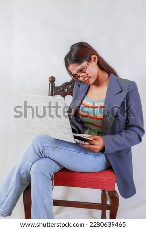 Happy young indian student siting on chair with laptop, notebook and pen, teenager indian student siting, thinking student, smiling indian student, business indian women, corporate office women