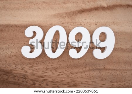 White number 3099 on a brown and light brown wooden background.