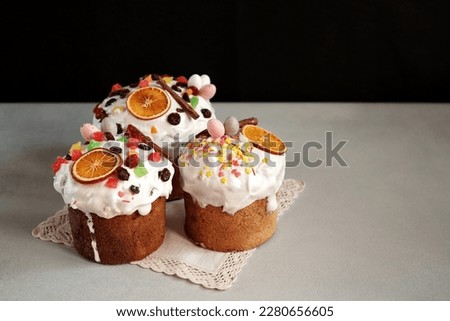 Traditional Easter Cakes decoreted with dried Fruits on Grey Background. Copy space for text