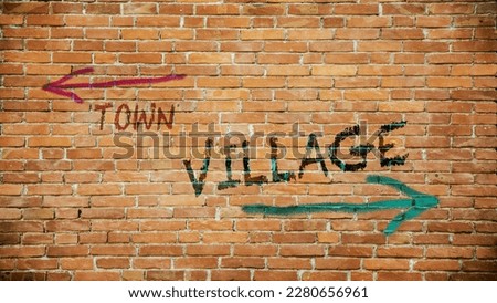 Street Sign the Direction Way to Village versus Town