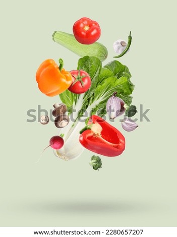 Many different fresh vegetables falling on beige background Royalty-Free Stock Photo #2280657207