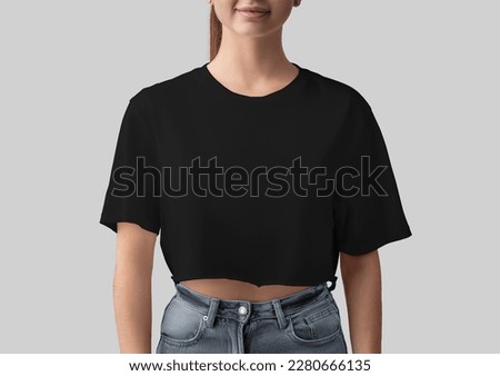 Mockup of black crop top on smiling girl, blank canvas bella shirt, front view, isolated on background. Free-cut fashion t-shirt template for design, print, advertising. Women's clothing close-up