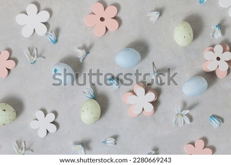 Easter decoration. Pastel colorful Easter eggs on light gray background, top view.