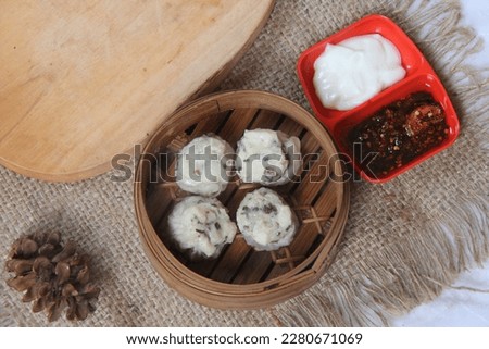 dimsum is food that comes from China, dimsum is usually served with hot tea when gathering with family, the photo is taken indoors with a little studio light