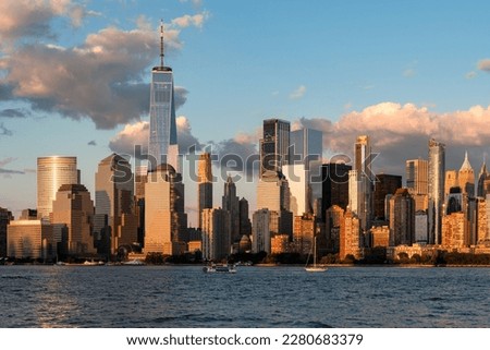 New York skyscrapers at sunset, office buildings and waterfront, financial corporation and world business center. Manhattan skyline in the evening