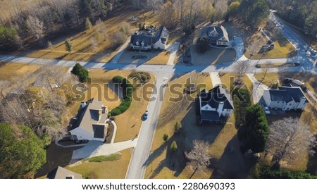 Aerial view low density housing design in upscale residential neighborhood group of new development two story houses with no fence, well-trimmed yards Flowery Branch, Georgia, USA. Road intersection