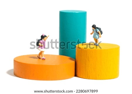 Miniature people toy figure photography. Girl kindergarten students playing Montessori wooden block. Isolated on white background. Image photo