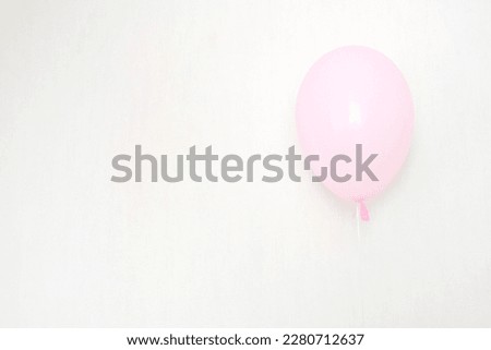 A  pink air balloon, copy space for your text, tender pastel colors for a girlish party