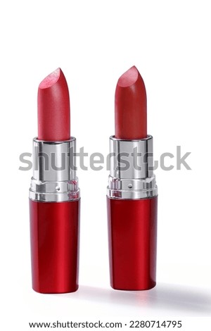 Open red lipstick tube on white background