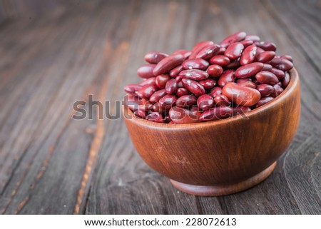 Red beans on wooden background - film effect style pictures