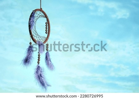 Beautiful dream catcher hanging against blue sky