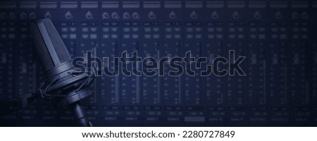 Vocal microphone with mixing screen device background for music production or radio broadcast banner with copy space Royalty-Free Stock Photo #2280727849