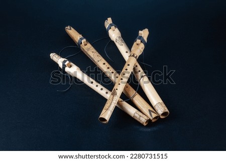 Native American flutes on a dark background