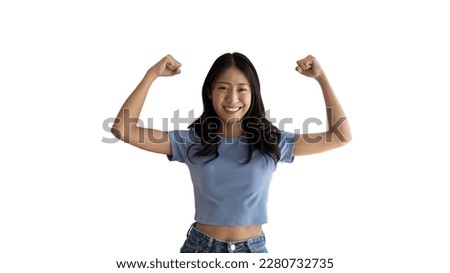 Woman flexing her muscles, Young Asian woman shows off her strength by flexing her jaw and showing off her power, Healthy, Happiness of your choice, White background. Royalty-Free Stock Photo #2280732735
