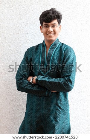 A smart and handsome man wearing green kurta - the Indian traditional outfit for occasions like Diwali, Navratri, New year, matrimonial, Indian Wedding, Ganpati, house warming pooja,  etc