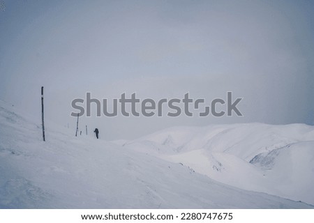 Winter hiking through Styrian Alps below the summit of Hochschwab mountain. Snow covered peaks surround the mountainous landscape which felt really magical.