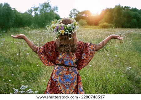 girl in flower wreath on green meadow, abstract natural background. Floral crown, symbol of summer solstice. Midsummer, wiccan Litha sabbat. pagan slavic holiday Ivan Kupala. wellbeing prayer Royalty-Free Stock Photo #2280748517