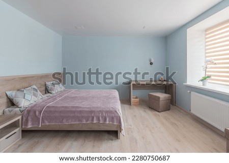 Hotel room with a large double bed in light colors. Royalty-Free Stock Photo #2280750687