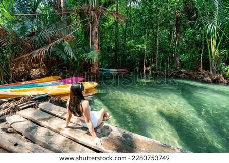 Young woman tourist relaxing and enjoying at klong nam sai in Krabi, Thailand Royalty-Free Stock Photo #2280753749