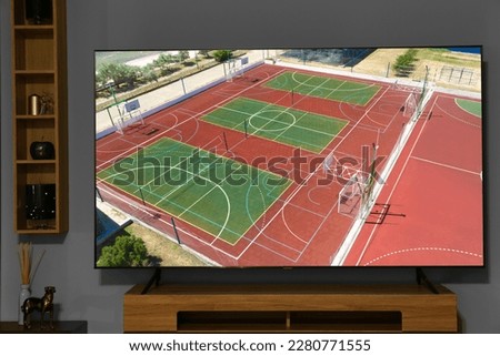 Tv with sports show on screen in room