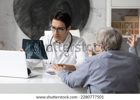 Old man visiting young male doctor rheumatologist in modern clinic Royalty-Free Stock Photo #2280777501