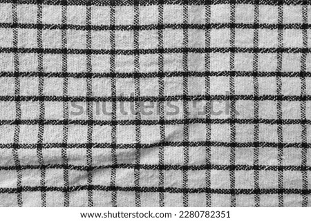 Classic black and white checkered kitchen towel texture. Fabric textile background with visible weave and thread detail. Ideal for web, print, packaging or for any other design project
