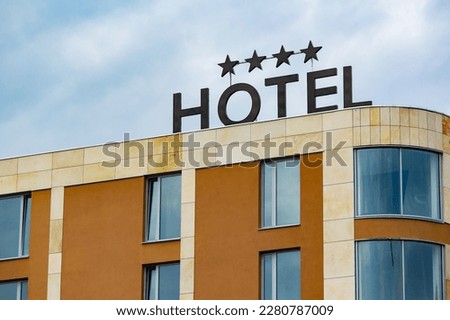 Building of generic 4-star hotel with a badge on a roof