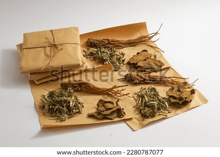 Angelica root, Chinese motherwort and Rhubarb root and rhizome displayed on papers. Traditional medicine to reduce inflammation and boost immunity.