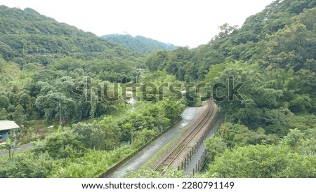 The view of the railway with sidewalk in the country near Wanggu waterfall in Pingxi in New Taipei City in Taiwan